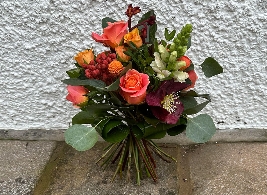 A bright bouquet with orange and purple flowers