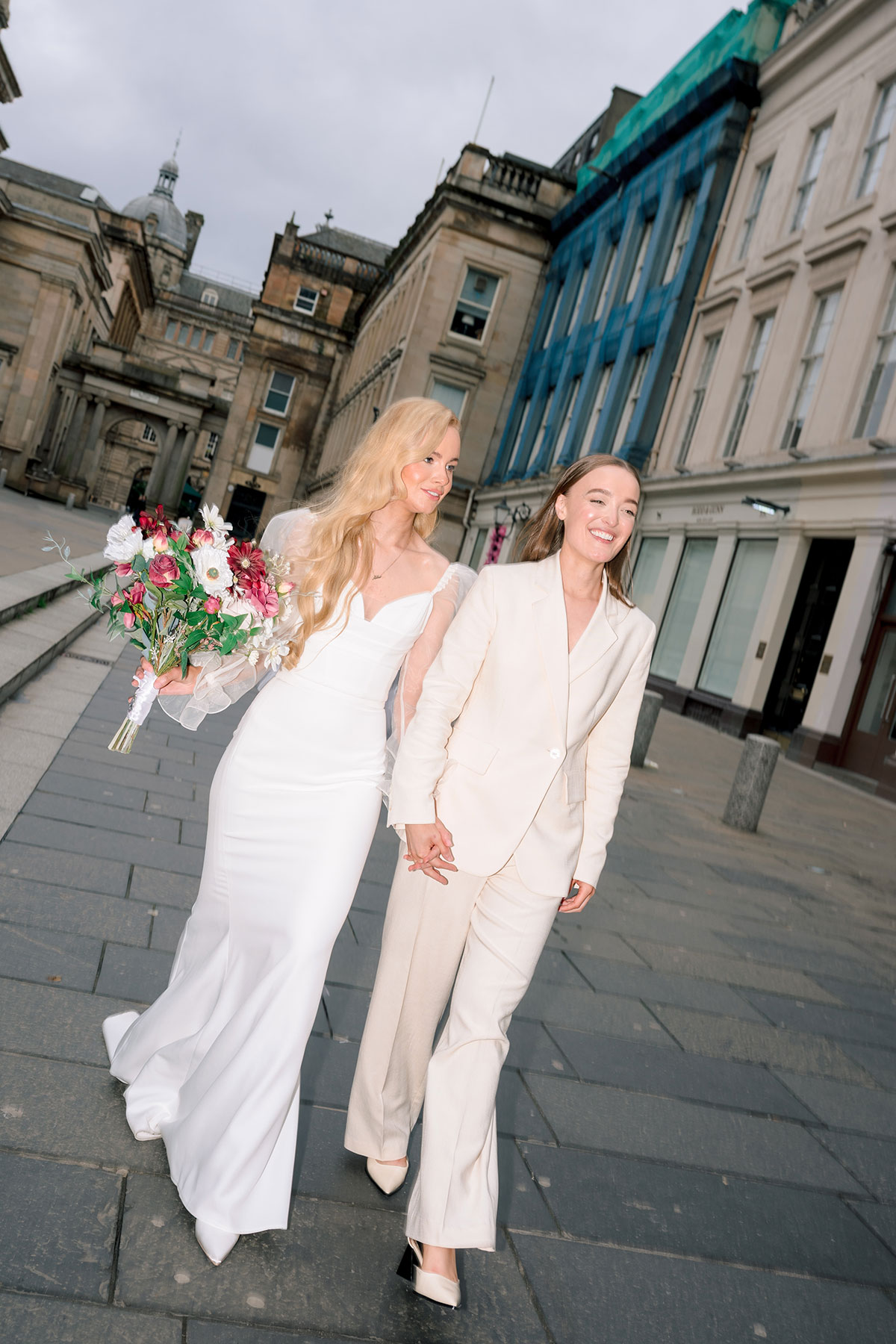 Brides walking through Royal Exchange Square, Glasgow.