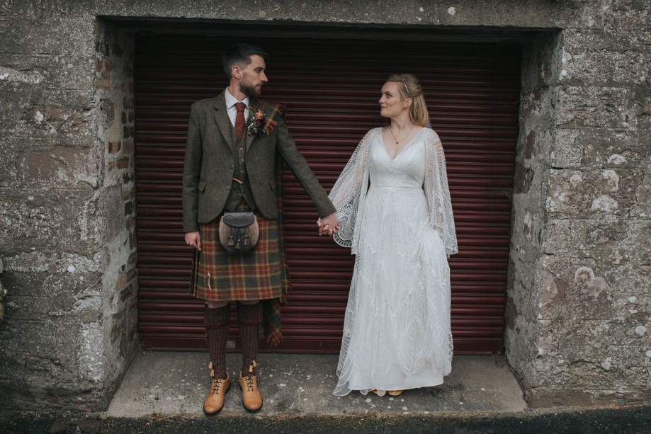 Couple hold hands and look at each other