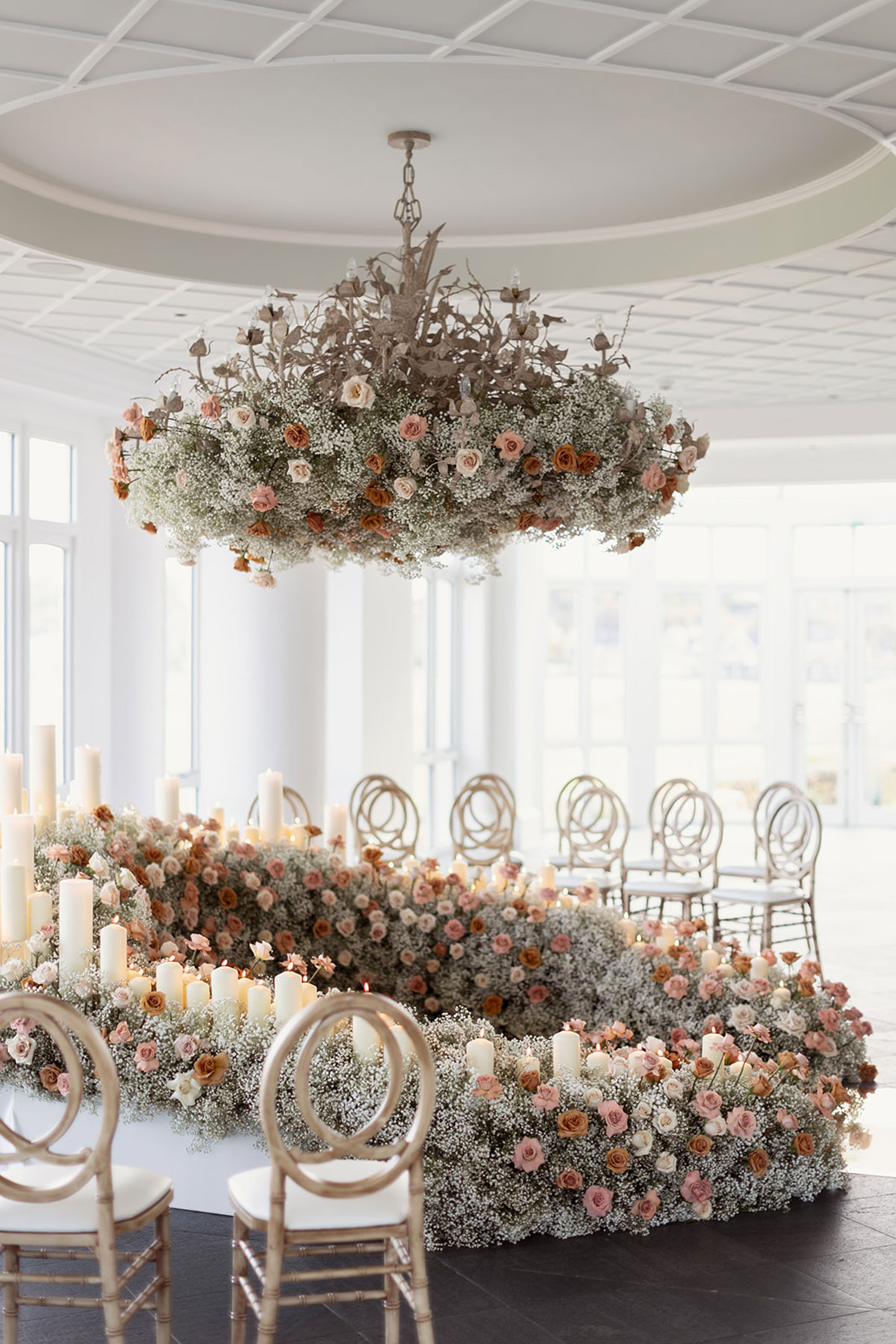 Old Course Hotel Conservatory wedding ceremony styling with rose and gypsophila florals and pillar candles, St Andrews