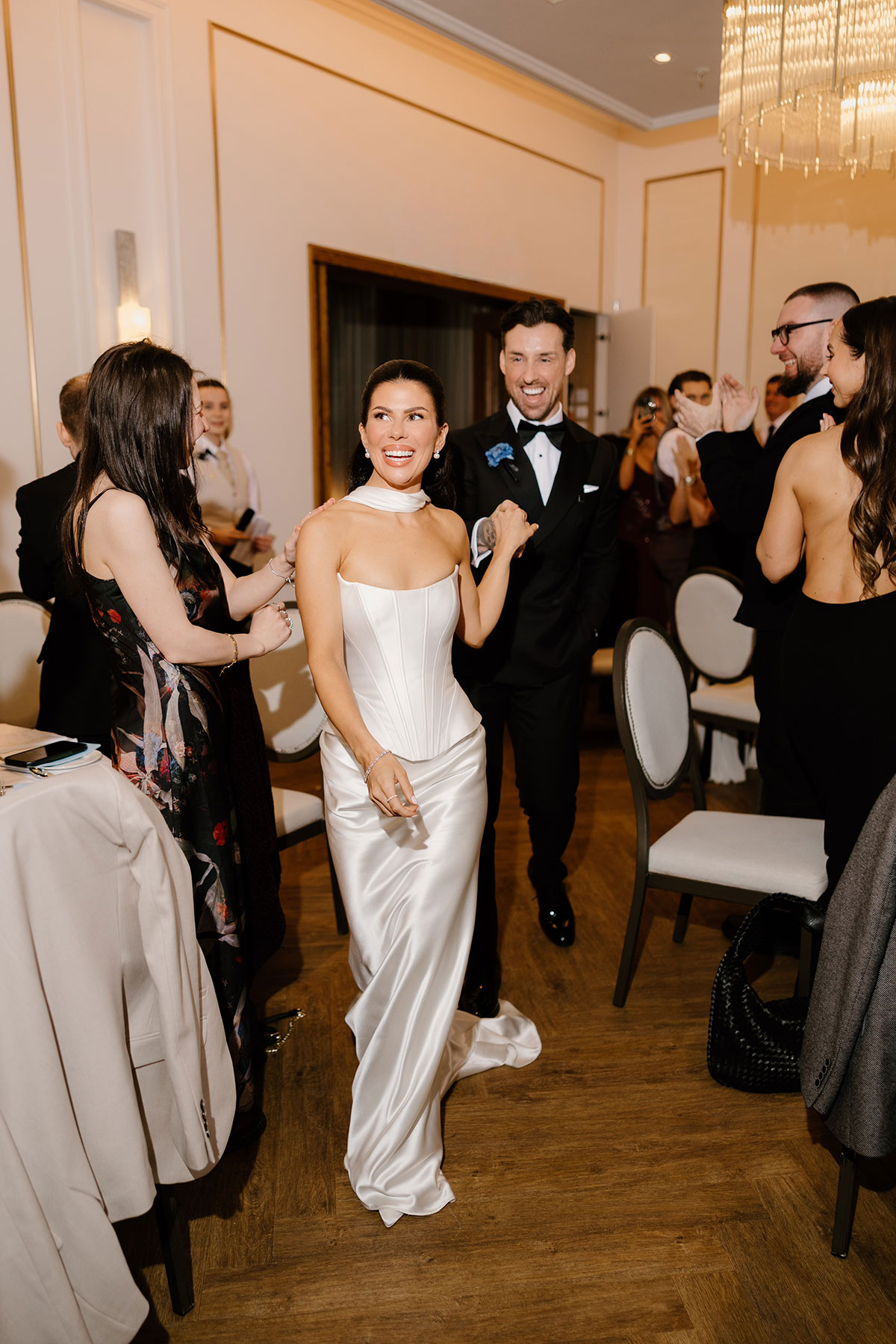 Bride and groom making joyful entrance to reception at The Exchange wedding venue
