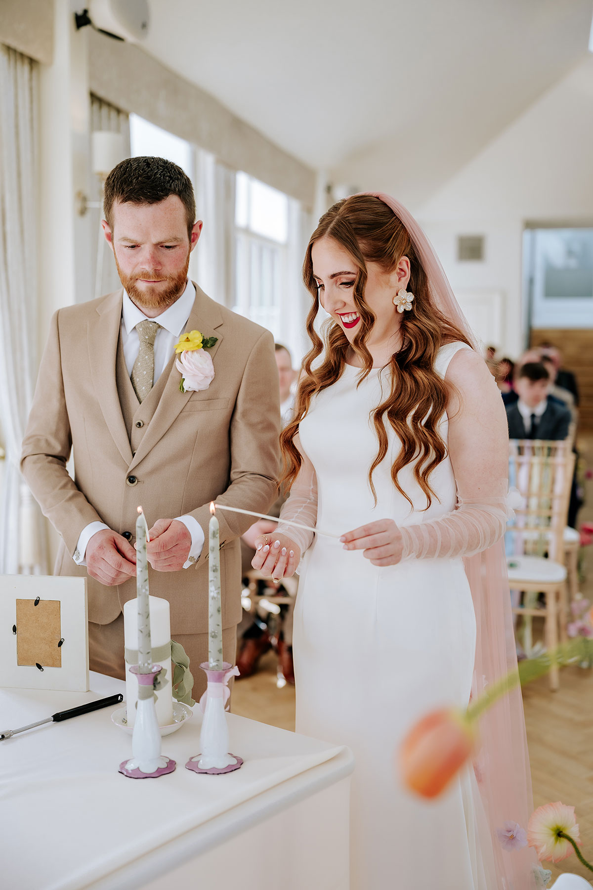 bride and groom candle lighting during wedding ceremony 