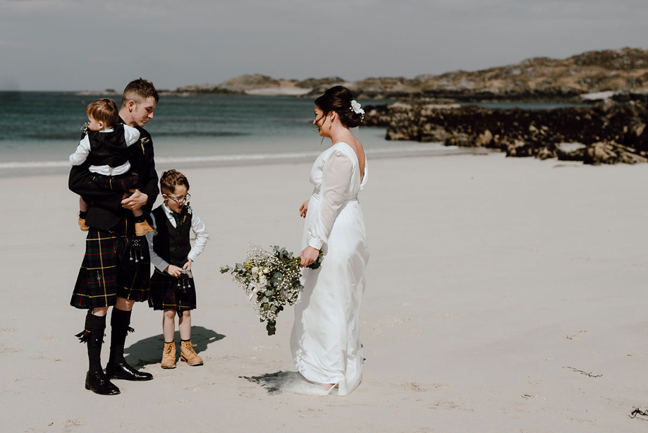 Bride and groom do first look on the beach with their sons