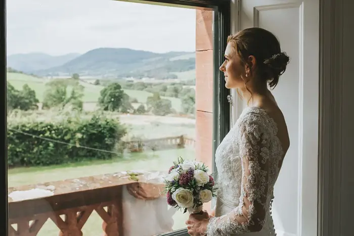 A bride looking out of a window at Dun Aluinn
