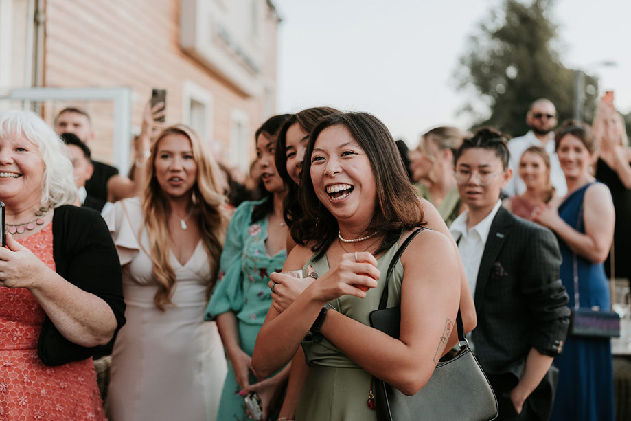 laughing wedding guests