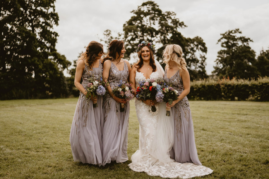 The bride poses with three bridesmaids