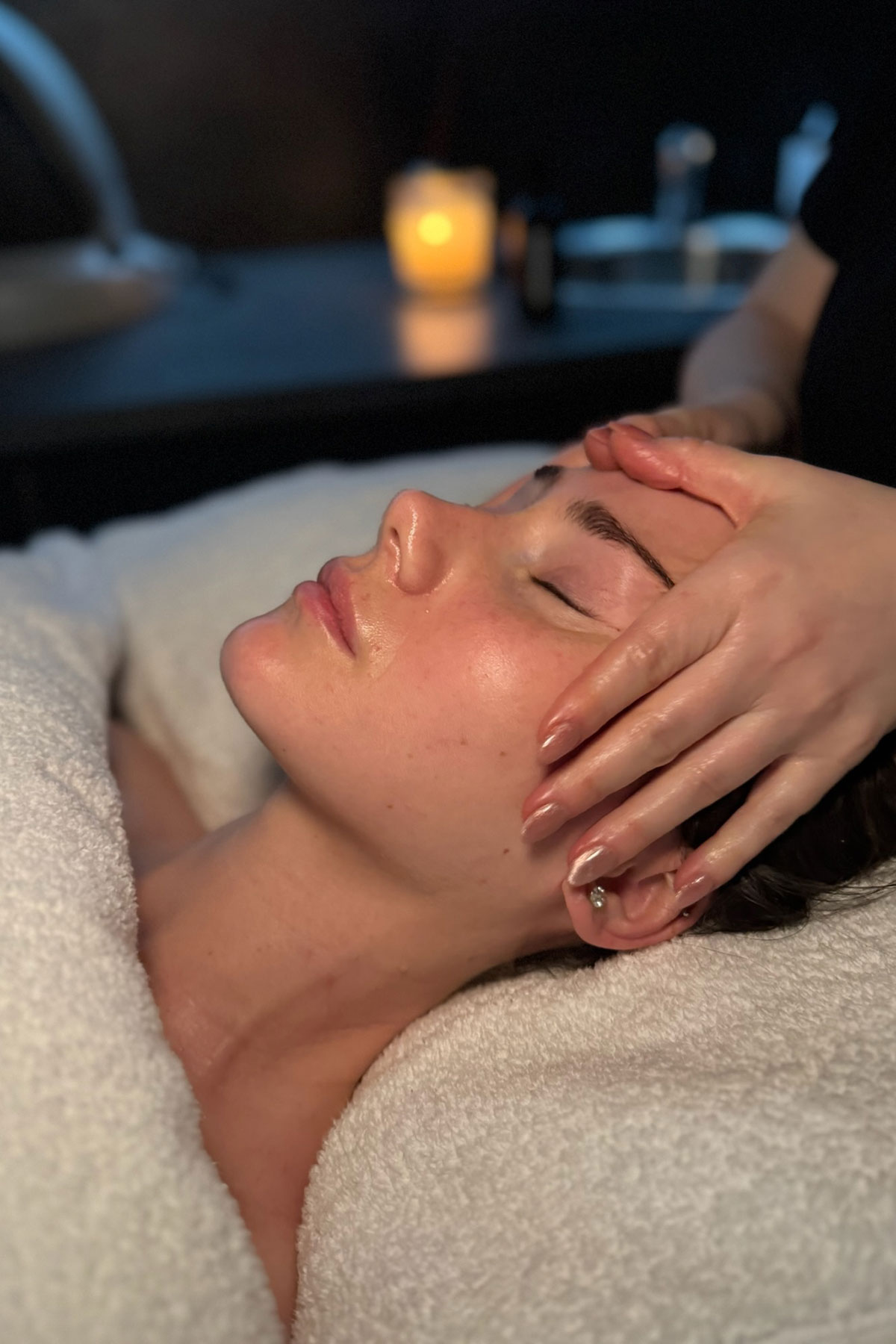 Close-up of a client enjoying a relaxing facial massage at FAB Salons in Glasgow