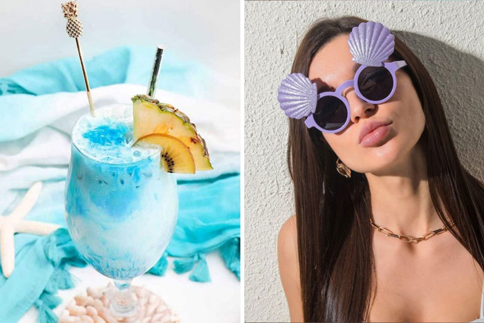 Blue drink with pineapple slice in it and woman wearing purple shell glasses