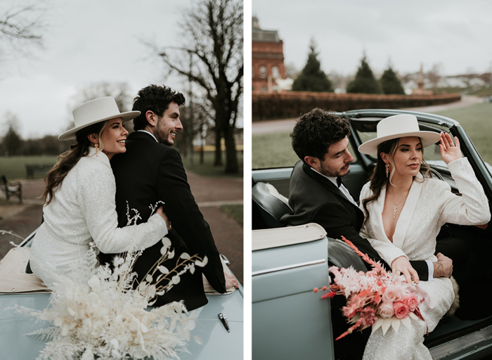 on the left a man in a black suit and a woman in a white suit sit together hugging on top of a blue convertible car, on the right they are sitting inside the car and the woman is holding a pink bouquet