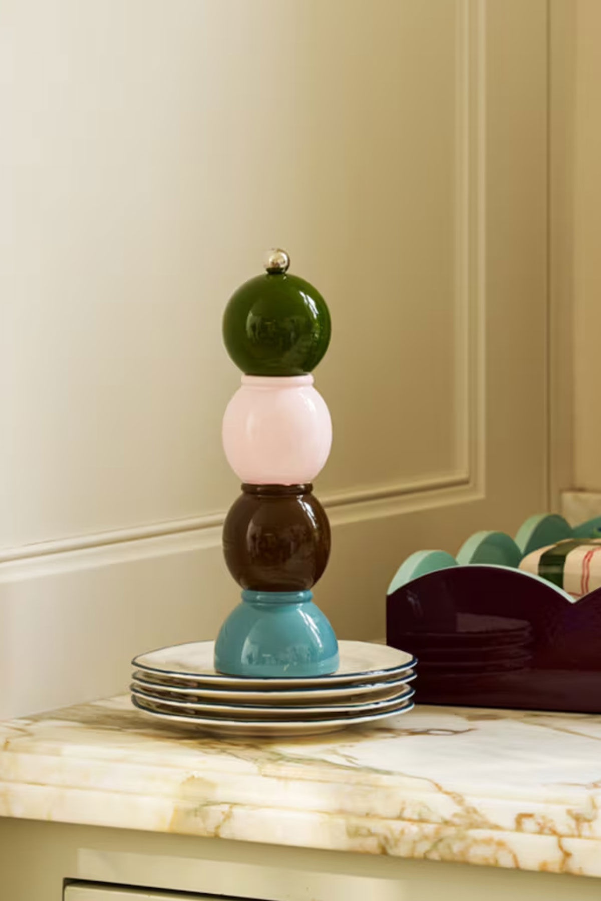 Colourful Addison Ross bobbin salt or pepper mill styled on stacked plates as a wedding gift idea for couples who love homeware