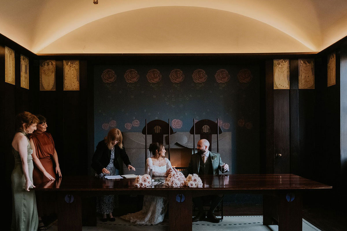 Bride and groom signing marriage license