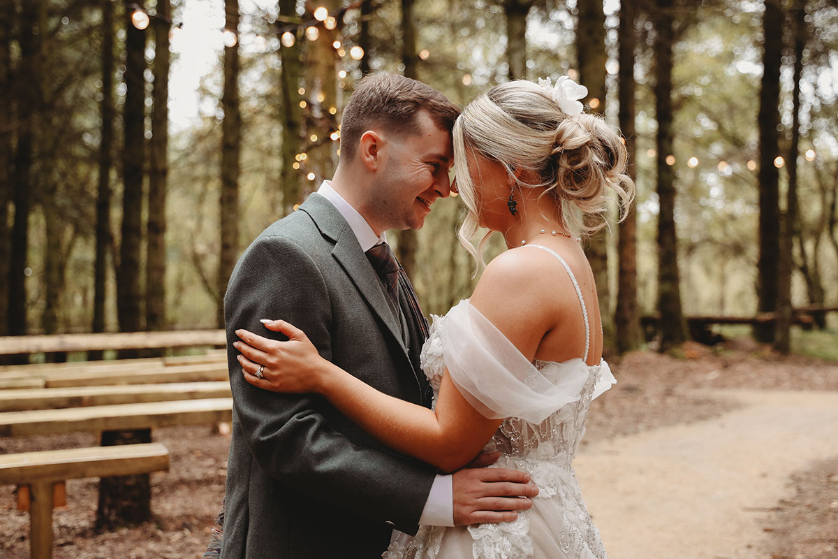 Bride and groom sharing an intimate portrait among the trees after their woodland wedding ceremony in Scotland