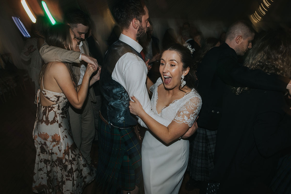 bride smiles during ceilidh dance during wedding at harvest moon holidays 