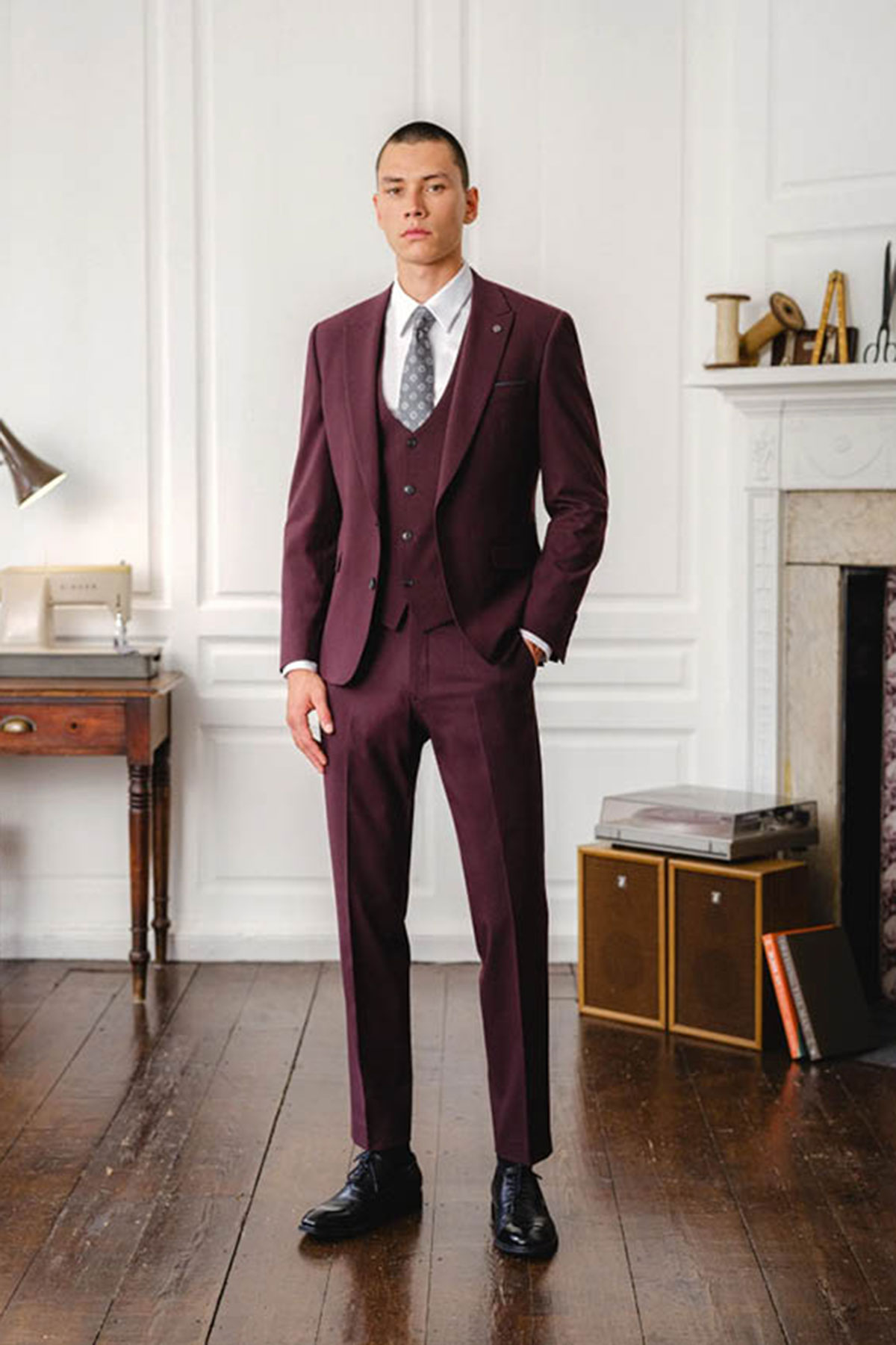 a model wearing a burgundy suit