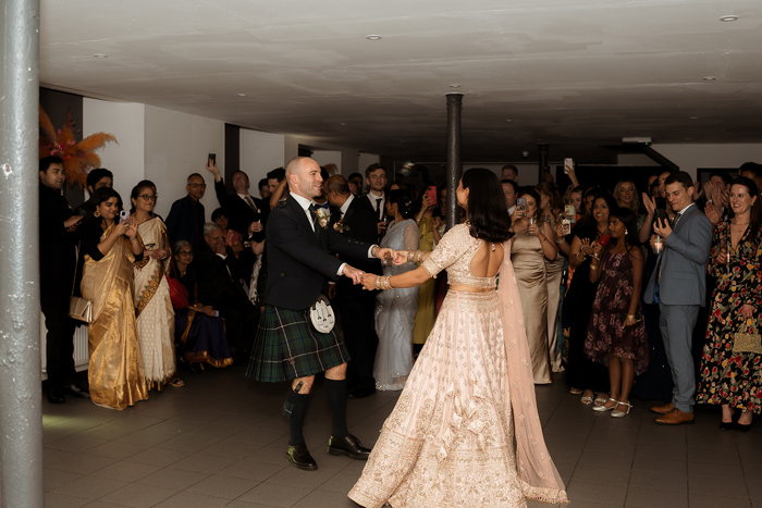 A Bride And Groom Dancing At The Haberdashery In Glasgow As Wedding Guests Look On