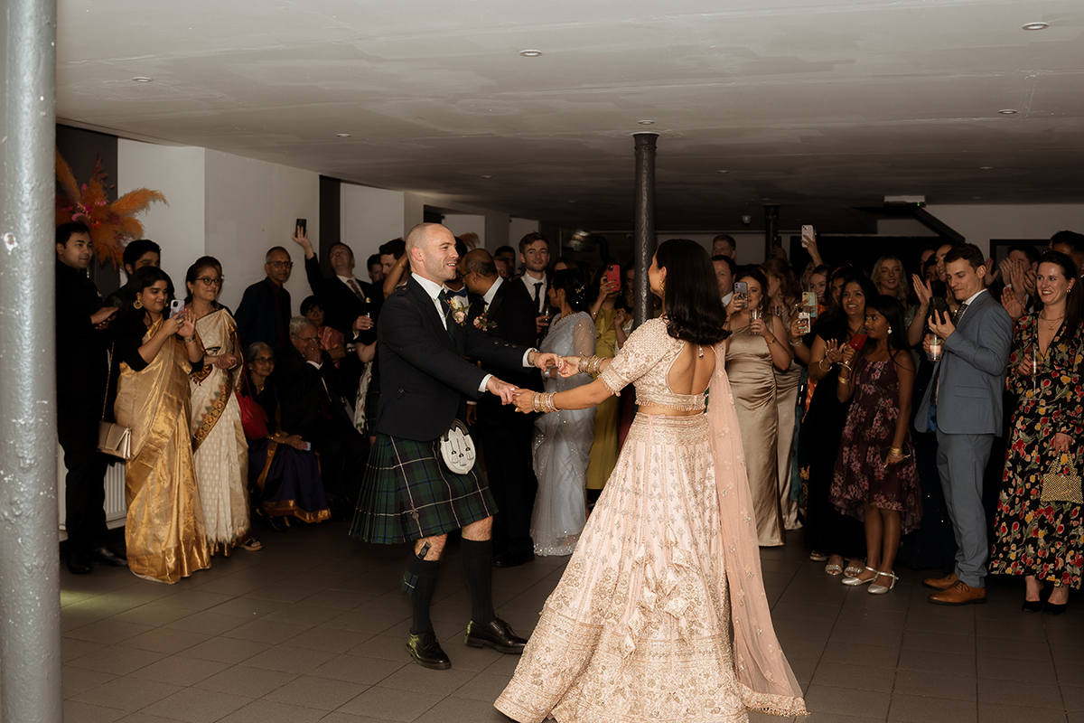 A Bride And Groom Dancing At The Haberdashery In Glasgow As Wedding Guests Look On