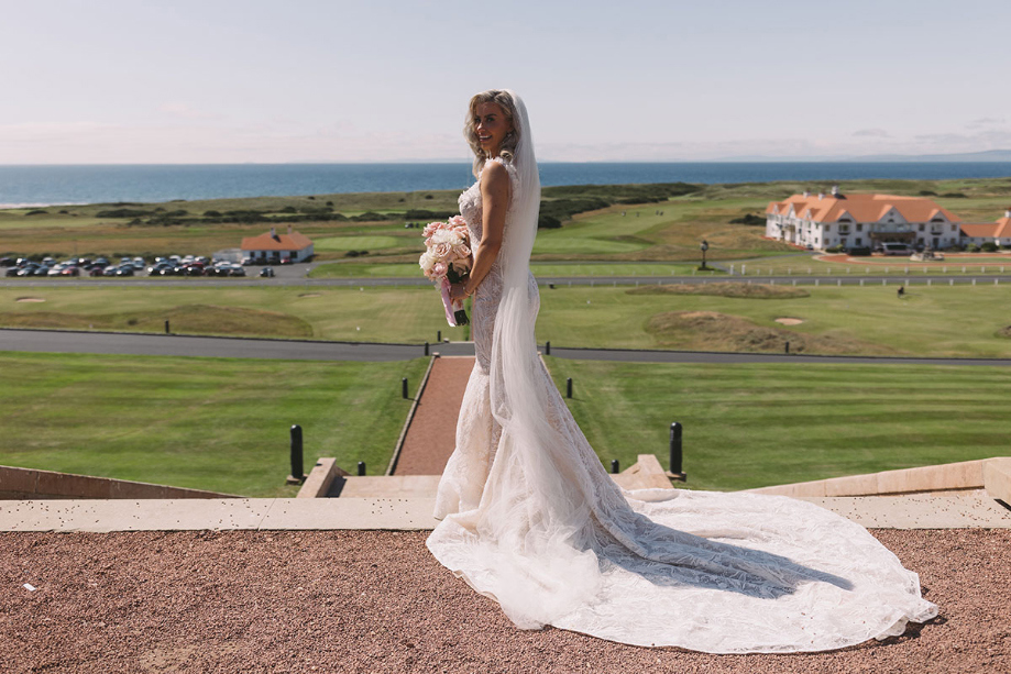 Bride poses outside Trump Turnberry in Opus Couture dress