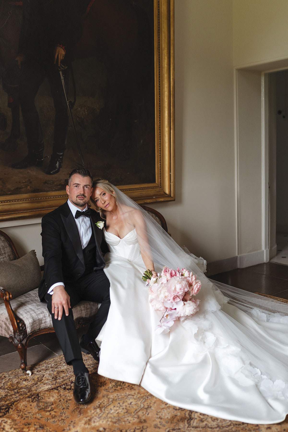 Bride and groom portrait inside Boturich Castle with the bride holding her pink wedding bouquet after their Loch Lomond wedding ceremony.