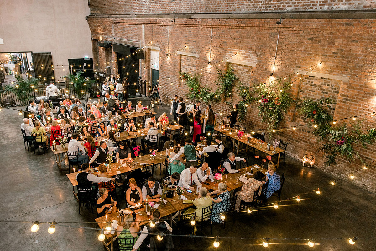 Overhead view of guests seated at long banquet tables during a wedding reception