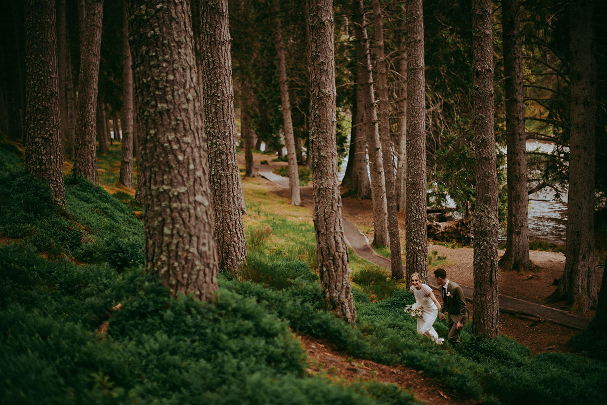 bride and groom walking through woods near mar lodge