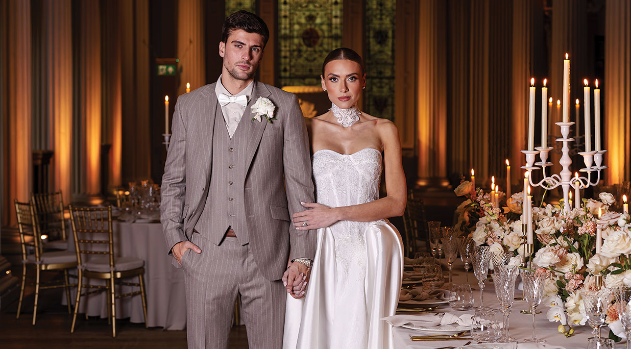 A bride and groom standing in the Upper Library at The Signet Library in Edinburgh