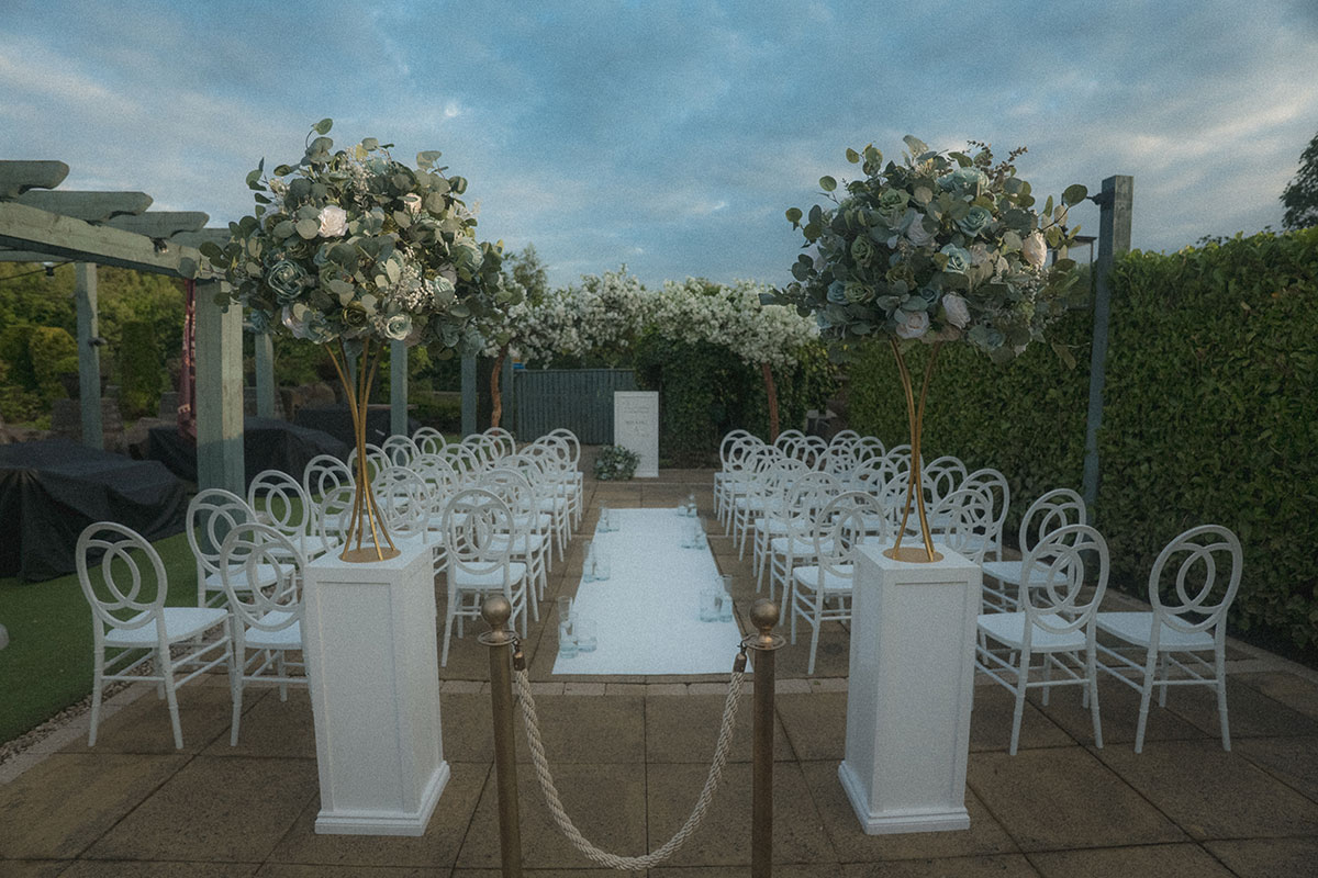 ceremony set up with white chairs and flowers for a wedding ceremony at the river inn in glasgow