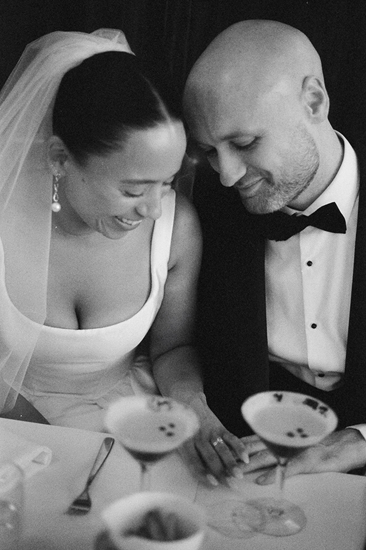 Bride and groom sharing espresso martinis at New York restaurant after elopement
