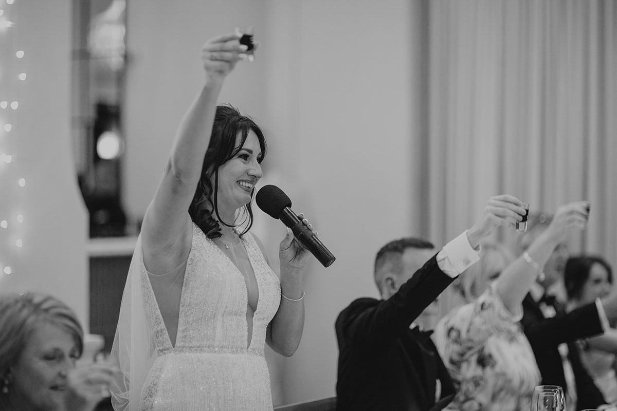 Bride raising a toast during wedding speeches at Boschendal Wine Estate reception in Cape Town, South Africa