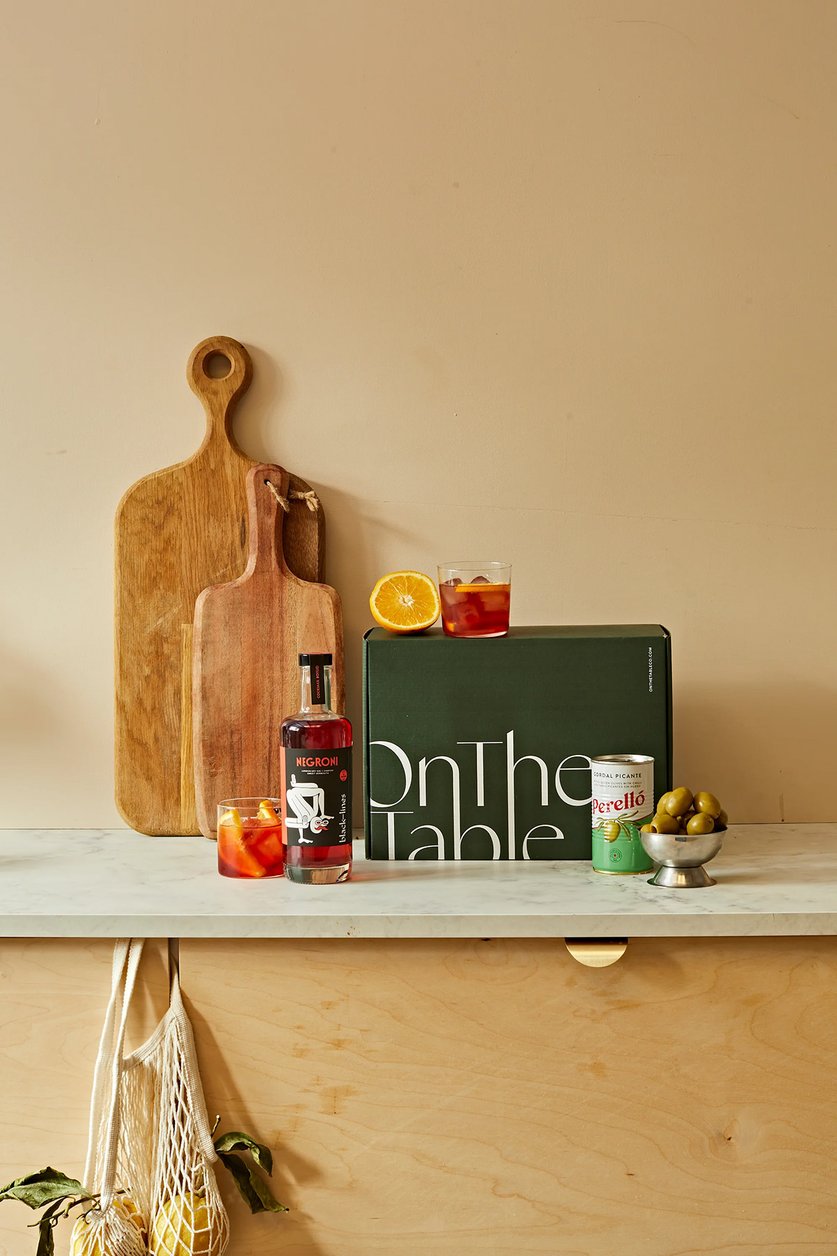 On The Table aperitif gift box with negroni cocktail ingredients and snacks, a thoughtful wedding gift for couples who enjoy hosting