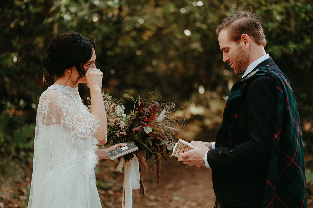 Bride wipes away tears as the couple exchange private vows and letters before their Cambo Country House wedding ceremony.
