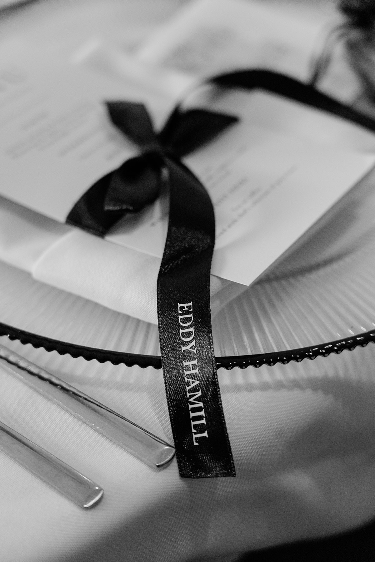 Personalised wedding place setting tied with black ribbon on reception table at Brisbane House Hotel