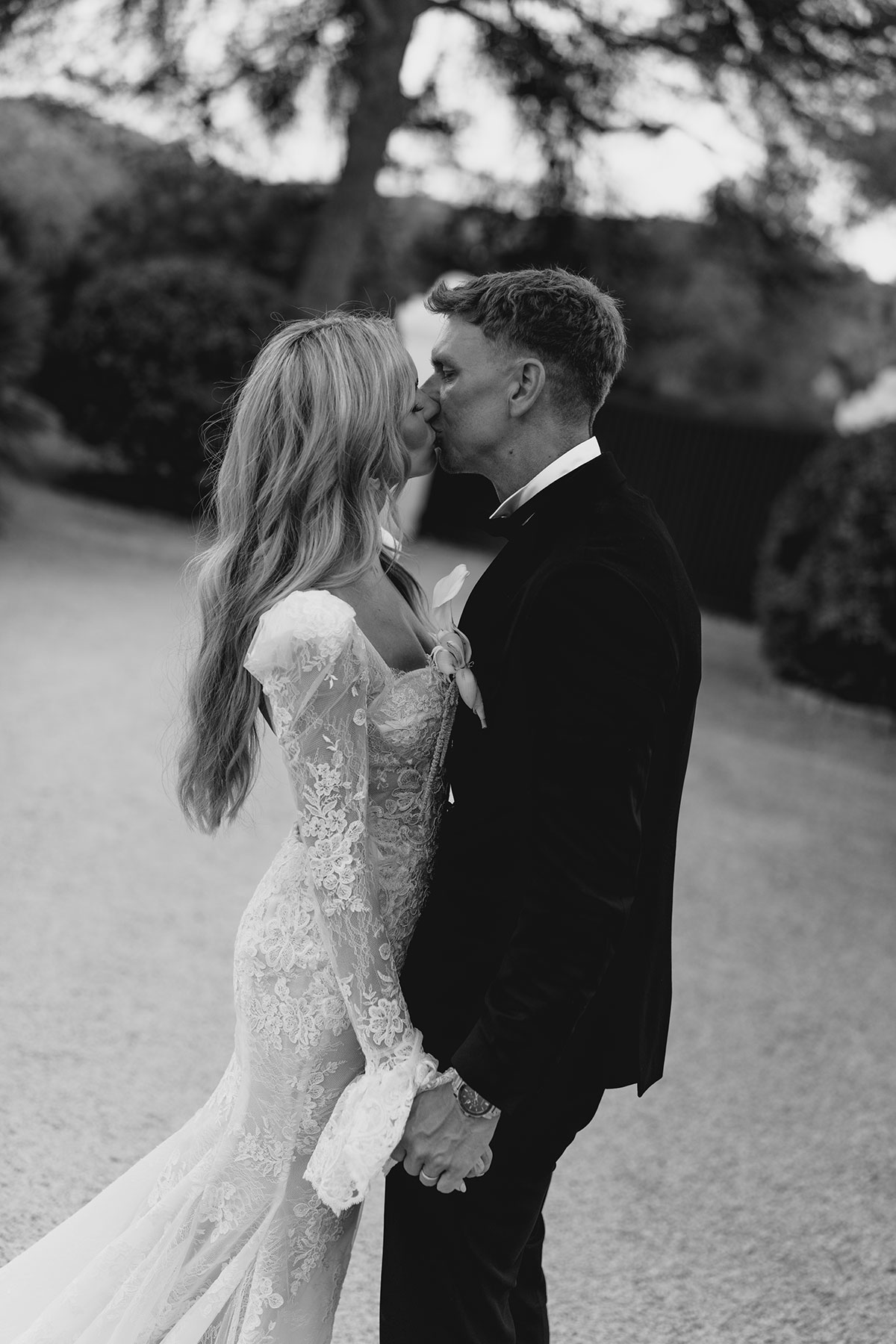 Black and white portrait of bride and groom kissing after Can Rafal Ibiza destination wedding ceremony