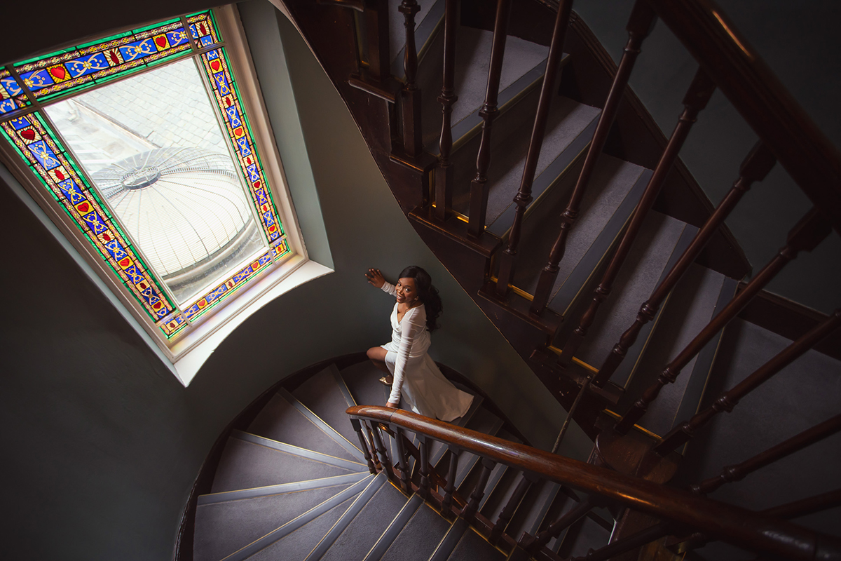 A bride walking up the staircase at The Scott Hotel