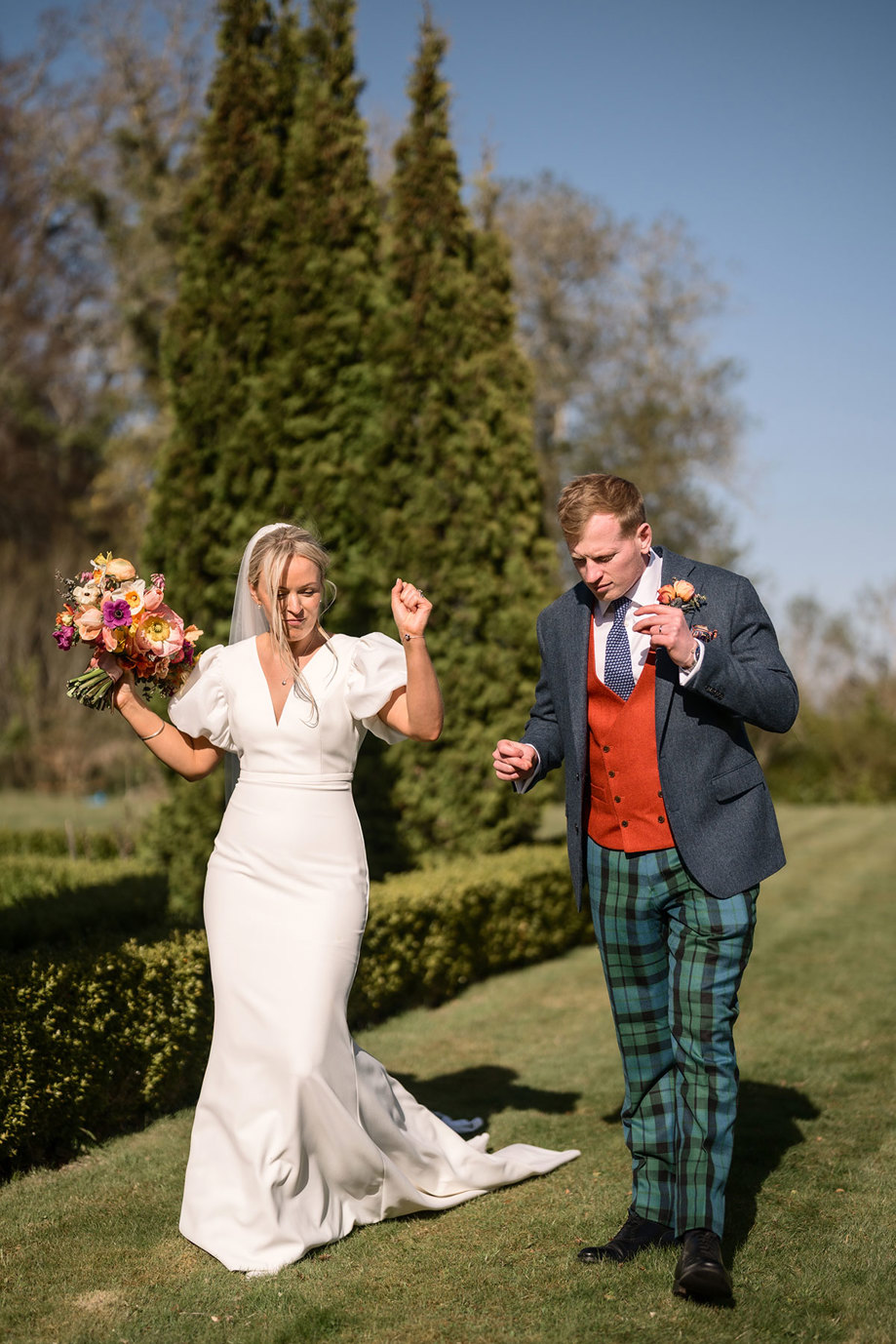 bride and groom dance on the grass during wedding at achnagairn castle