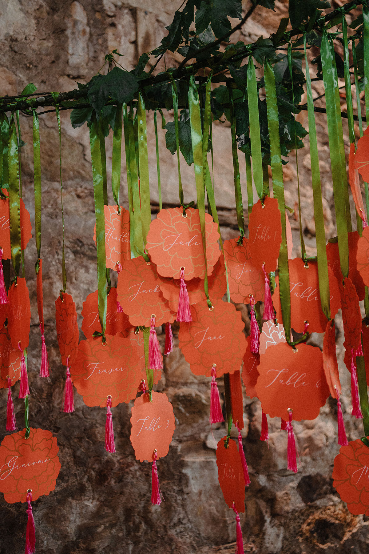 Orange marigold paper flower interactive table plan at a Kinkell Byre wedding.