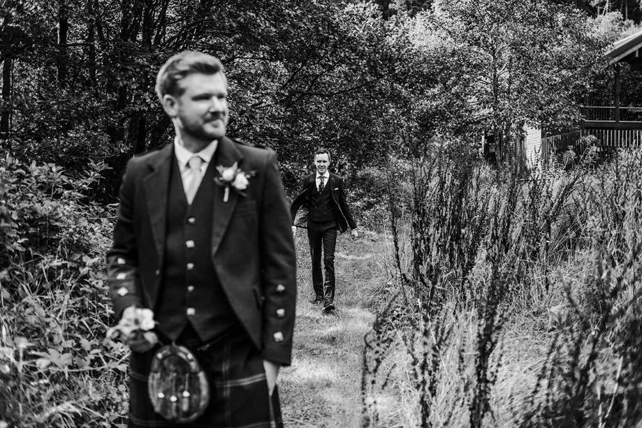 Black and white images of sweet first look between the grooms