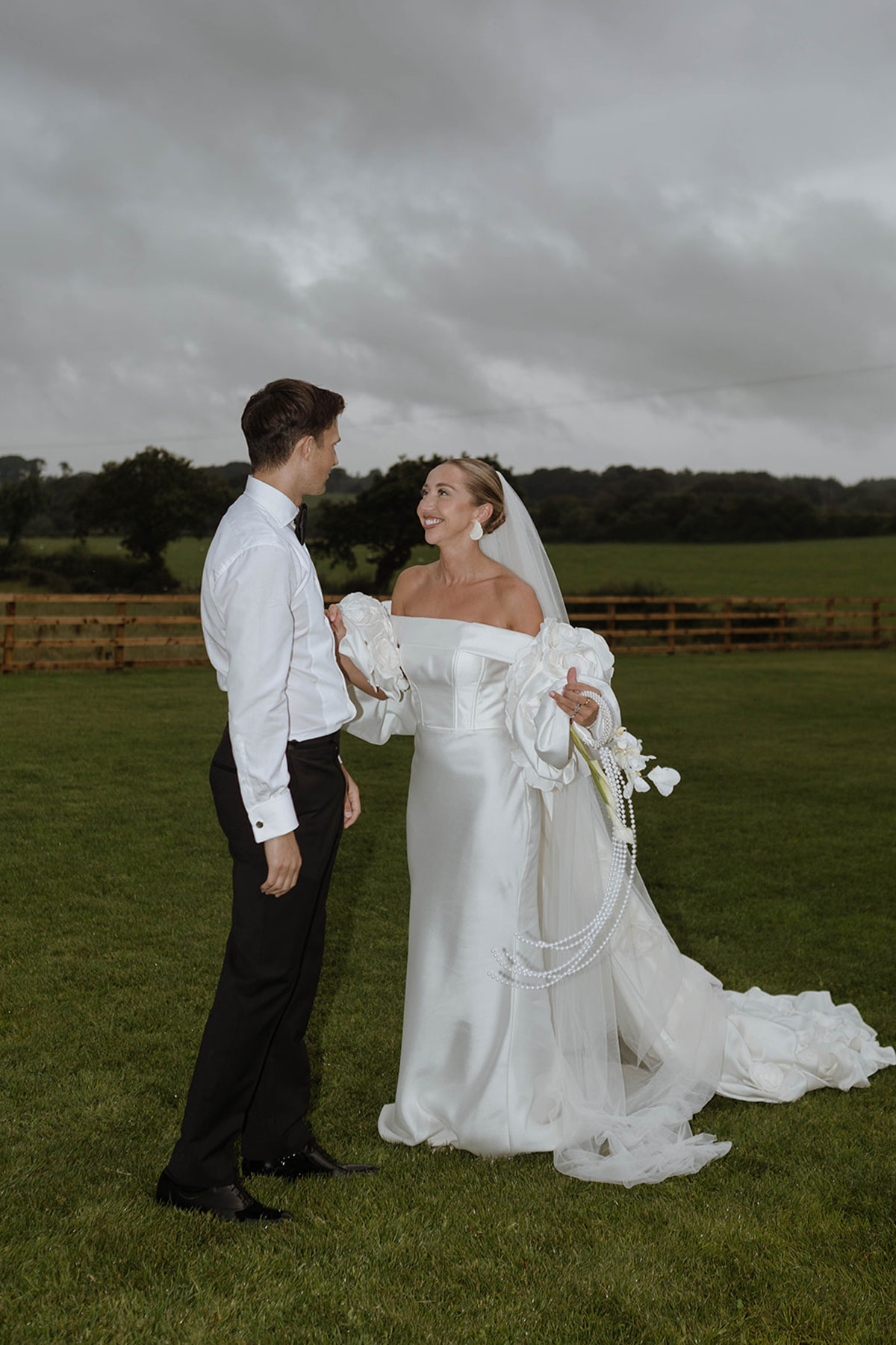Bride and groom portrait in countryside field during summer wedding on family farm in Ayrshire