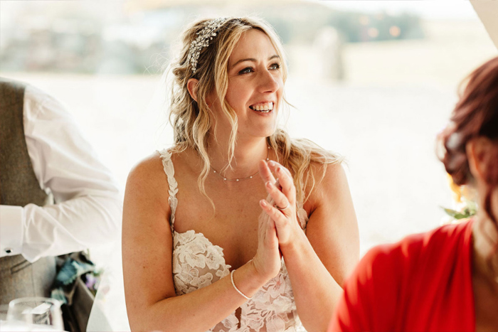 Image of bride smiling and clapping her hands