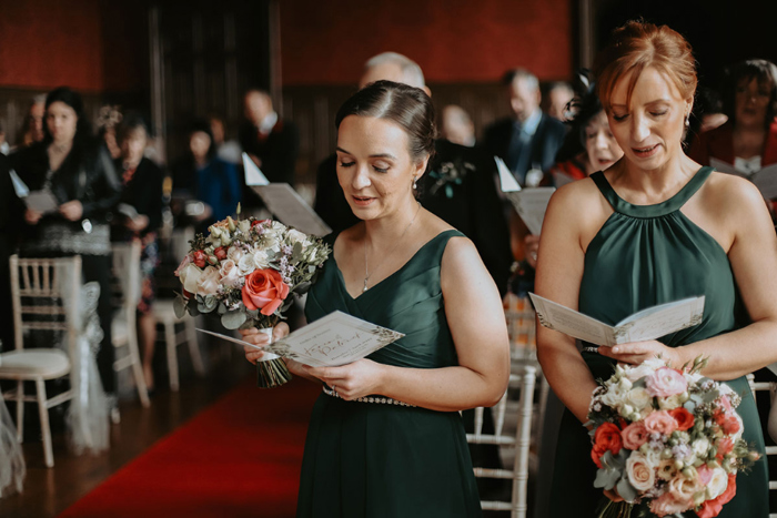 Bridesmaids sing hymns during the service