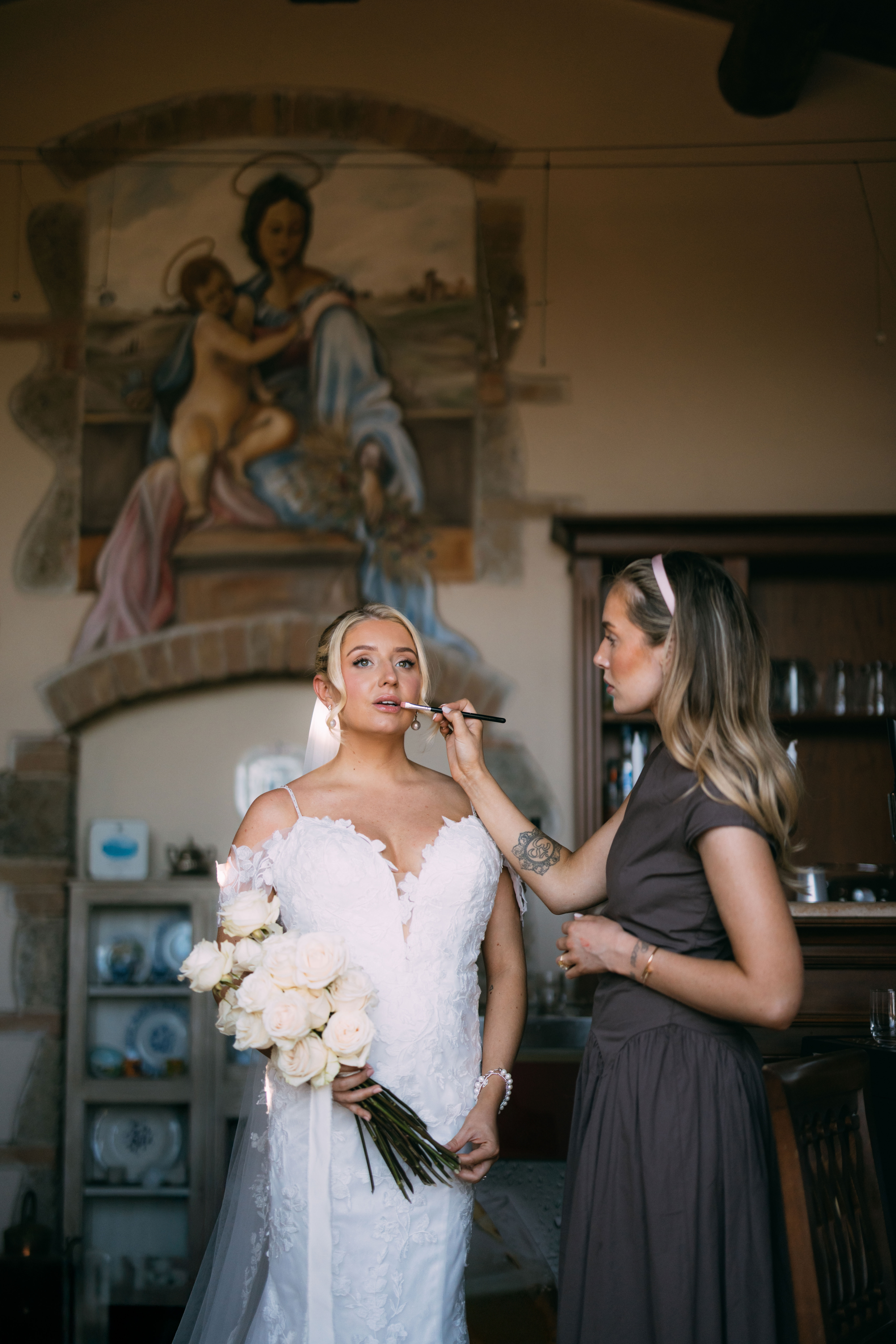 Bride getting makeup done on wedding morning at Antico Borgo San Lorenzo Tuscany