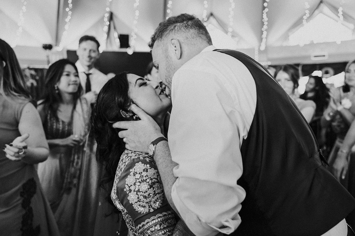 Bride and groom sharing a kiss on the dance floor during their evening wedding reception at Atholl Palace Hotel