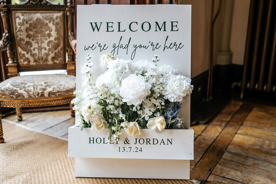 welcome sign for wedding at mar hall with cream and white flowers