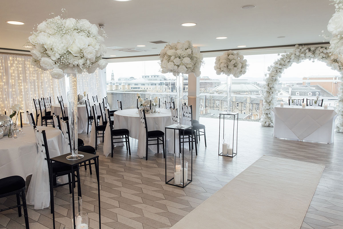 SKYBar Edinburgh reception space with floral centrepieces and panoramic city skyline views