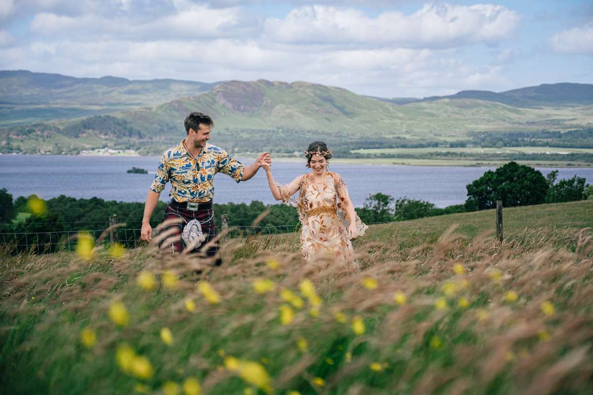 countryside-portrait.jpg Couple walking through long grass at Ardoch Loch Lomond with sweeping loch and mountain views