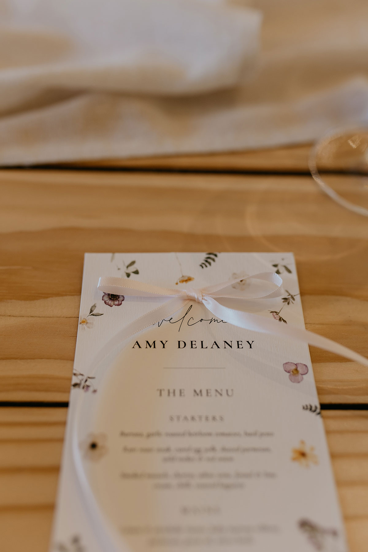 Floral wedding menu with ribbon place setting detail at Boschendal Wine Estate destination wedding in Cape Town