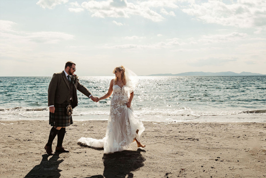 Couple portrait of bride and groom on the beach