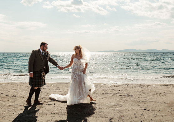 Couple portrait of bride and groom on the beach