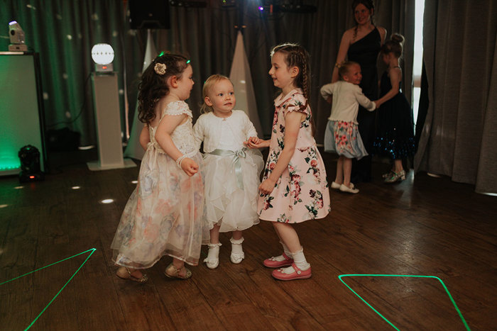 Three Young Children Wearing Wedding Attire Dancing
