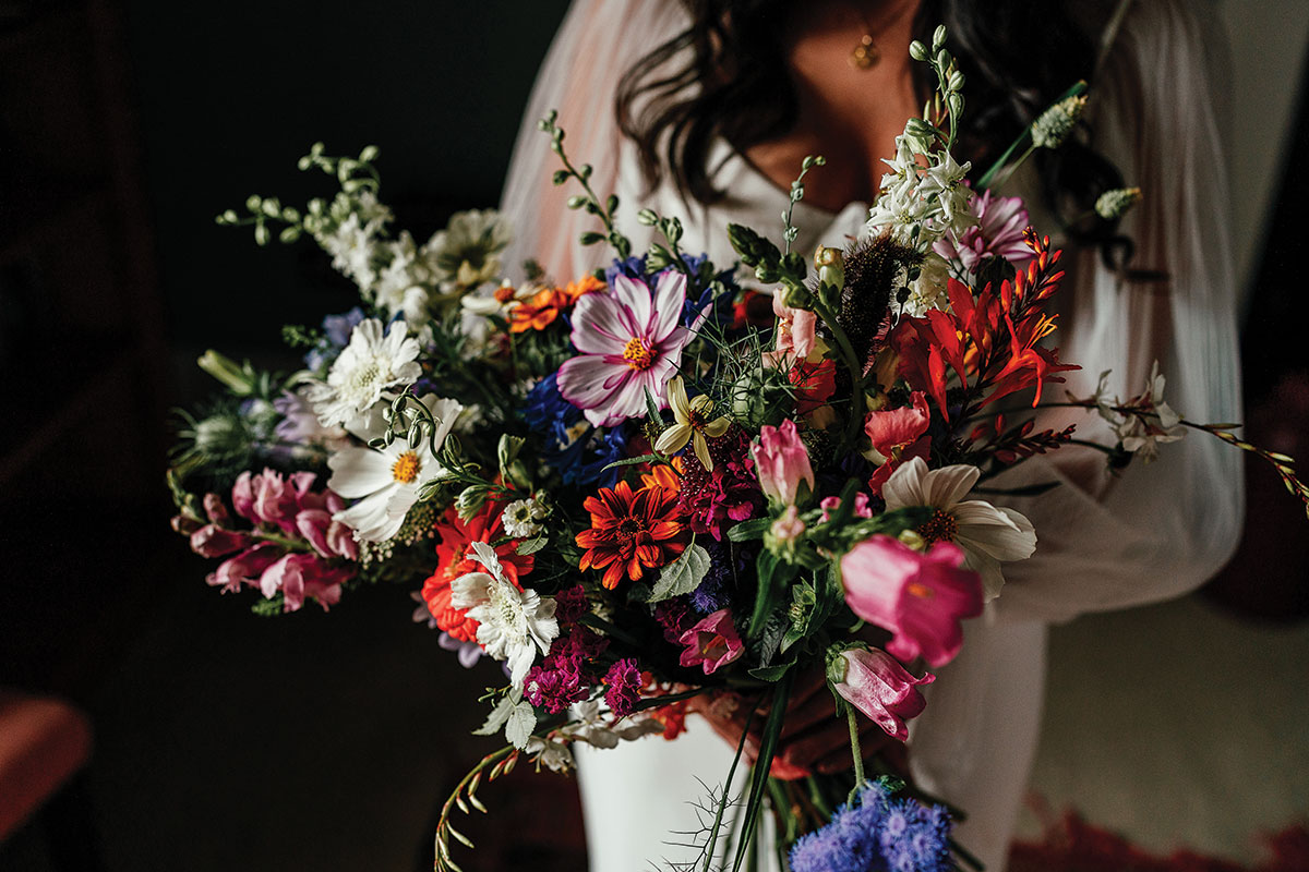 Colourful wildflower bridal bouquet featuring cosmos, daisies and seasonal blooms at a Scottish wedding.