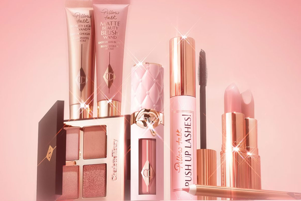 Charlotte Tilbury Pillow Talk makeup collection including blush, mascara, lipstick, eyeshadow and beauty wands in pink packaging.